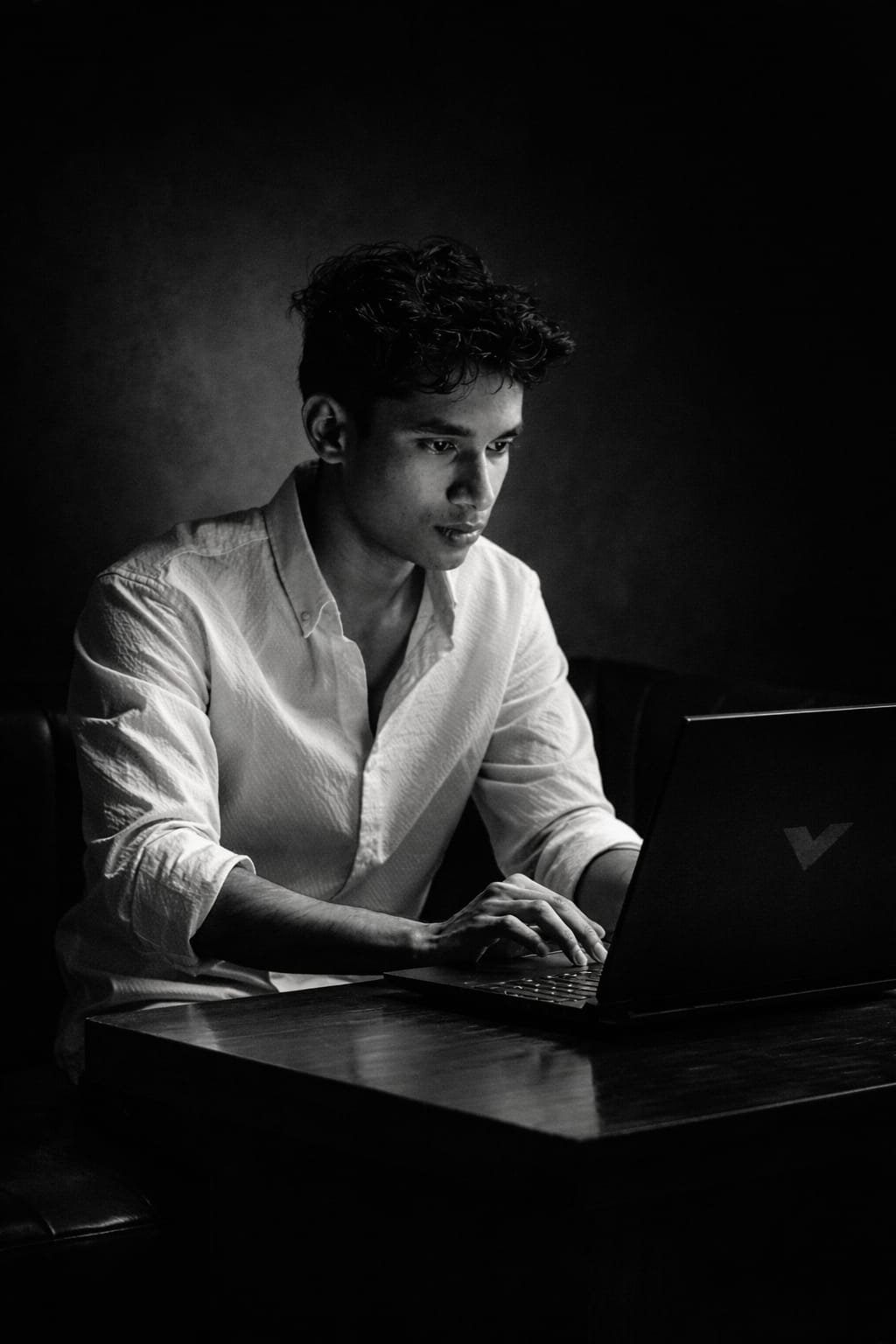 Digital Marketing Specialist Working on a laptop in a cafe atmosphere